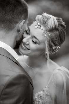 the first meeting of the bride and groom in wedding outfits in the park