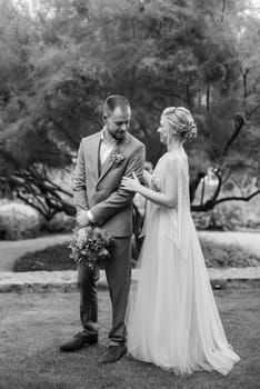 the first meeting of the bride and groom in wedding outfits in the park