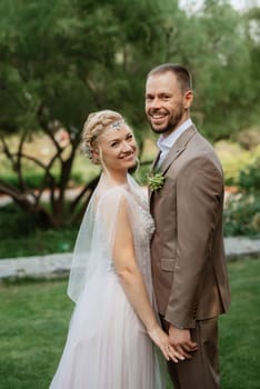 the first meeting of the bride and groom in wedding outfits in the park