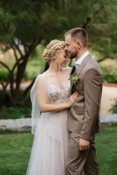 the first meeting of the bride and groom in wedding outfits in the park