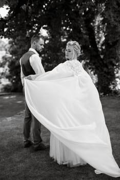 the first meeting of the bride and groom in wedding outfits in the park