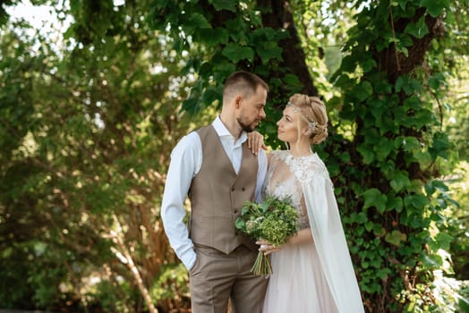 the first meeting of the bride and groom in wedding outfits in the park