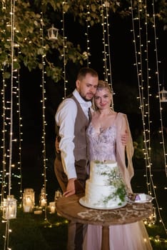 newlyweds happily cut, laugh and taste the wedding cake