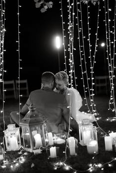 night wedding ceremony of the newlyweds in a country cottage on a green hill