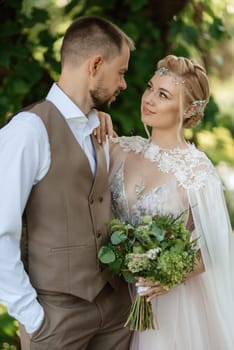 the first meeting of the bride and groom in wedding outfits in the park