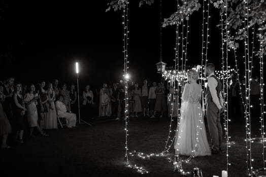 newlyweds happily cut, laugh and taste the wedding cake