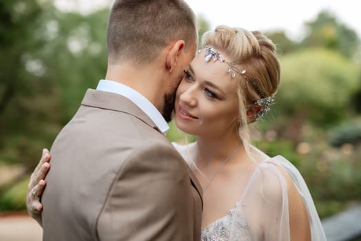 the first meeting of the bride and groom in wedding outfits in the park