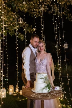 newlyweds happily cut, laugh and taste the wedding cake