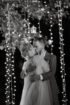 night wedding ceremony of the newlyweds in a country cottage on a green hill