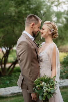 the first meeting of the bride and groom in wedding outfits in the park