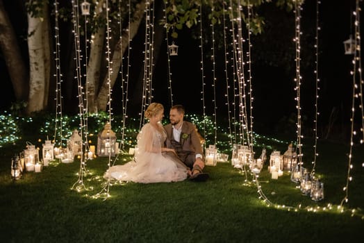 night wedding ceremony of the newlyweds in a country cottage on a green hill