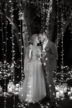 night wedding ceremony of the newlyweds in a country cottage on a green hill