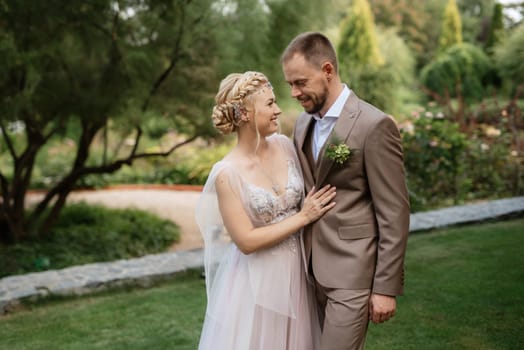 the first meeting of the bride and groom in wedding outfits in the park