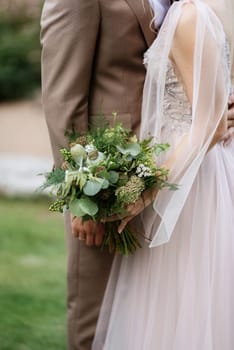 the first meeting of the bride and groom in wedding outfits in the park