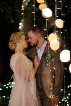 night wedding ceremony of the newlyweds in a country cottage on a green hill