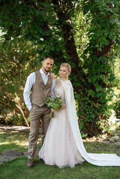 the first meeting of the bride and groom in wedding outfits in the park