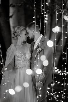 night wedding ceremony of the newlyweds in a country cottage on a green hill