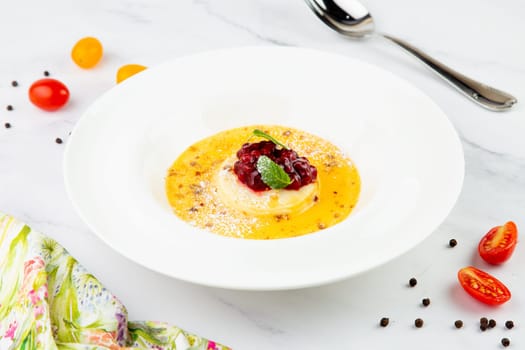 Ginger pumpkin soup with dumplings and berries. White background