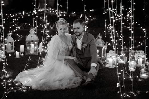 night wedding ceremony of the newlyweds in a country cottage on a green hill