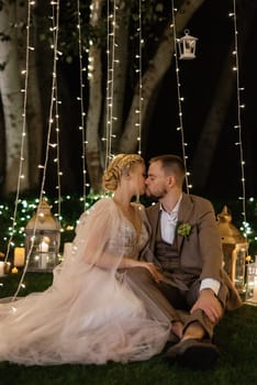 night wedding ceremony of the newlyweds in a country cottage on a green hill