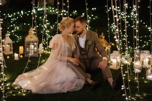 night wedding ceremony of the newlyweds in a country cottage on a green hill