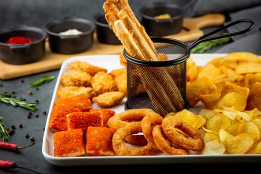 beer set with nuggets, breaded onion rings, fries and sauces