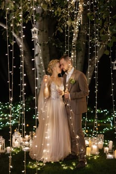 night wedding ceremony of the newlyweds in a country cottage on a green hill