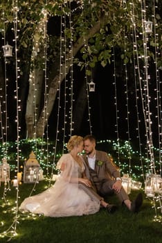 night wedding ceremony of the newlyweds in a country cottage on a green hill