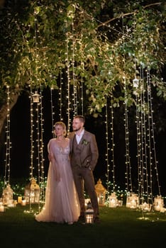 night wedding ceremony of the newlyweds in a country cottage on a green hill