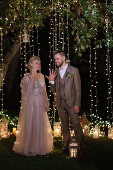 night wedding ceremony of the newlyweds in a country cottage on a green hill