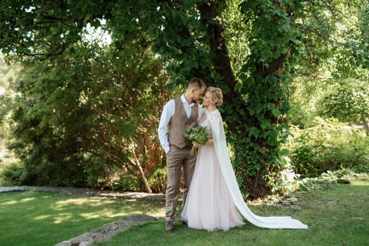 the first meeting of the bride and groom in wedding outfits in the park