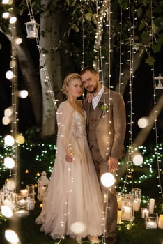 night wedding ceremony of the newlyweds in a country cottage on a green hill