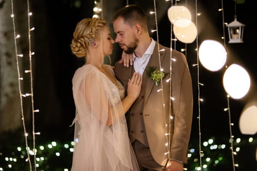 night wedding ceremony of the newlyweds in a country cottage on a green hill