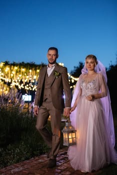 night wedding ceremony of the newlyweds in a country cottage on a green hill