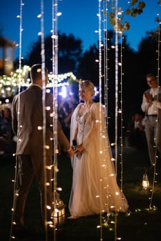 night wedding ceremony of the newlyweds in a country cottage on a green hill