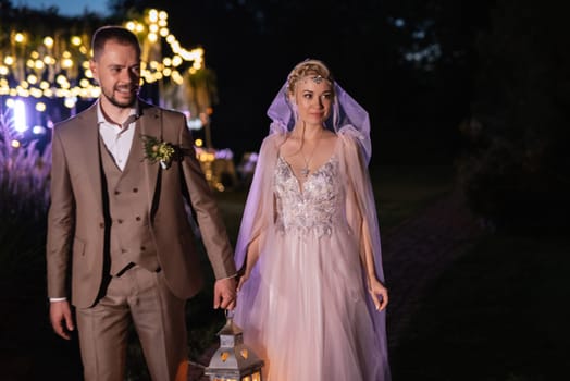 night wedding ceremony of the newlyweds in a country cottage on a green hill