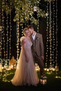 night wedding ceremony of the newlyweds in a country cottage on a green hill