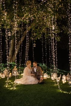 night wedding ceremony of the newlyweds in a country cottage on a green hill