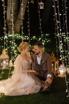 night wedding ceremony of the newlyweds in a country cottage on a green hill