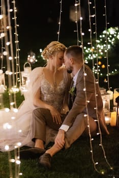 night wedding ceremony of the newlyweds in a country cottage on a green hill