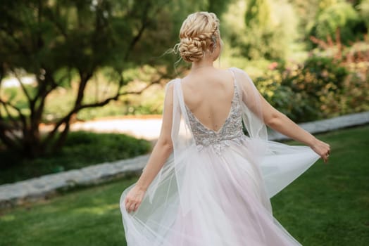 portrait of a happy bride in a light light dress on a green meadow in the park wearing elven accessories