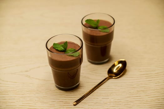 Beautiful Chocolate mousse in a glass on the table in 4k