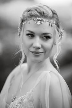 portrait of a happy bride in a light light dress on a green meadow in the park wearing elven accessories