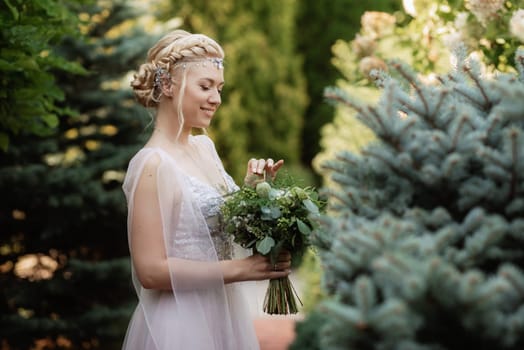 portrait of a happy bride in a light light dress on a green meadow in the park wearing elven accessories