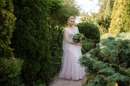 portrait of a happy bride in a light light dress on a green meadow in the park wearing elven accessories