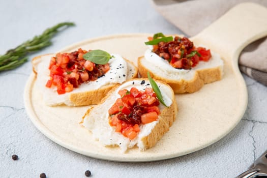 bruschetta with tomatoes and labneh cheese on a light background