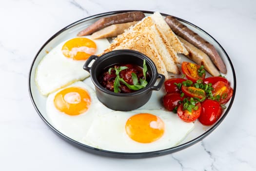 Breakfast of eggs and vegetables with cherry tomatoes and slices of bread