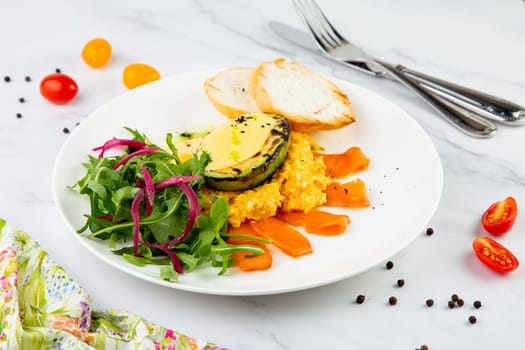 a mix of salmon, arugula salad, white bread and baked avocado with cheese