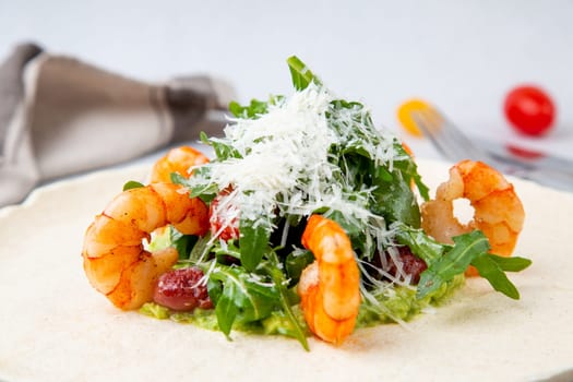 beautifully served shrimp with arugula and grated cheese