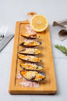 oysters scallops with red sea salt and citric acid on a wooden tray